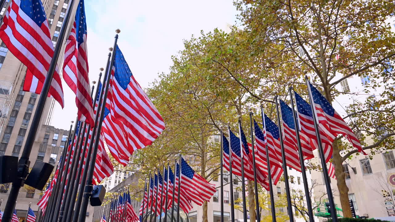 New York, USA, 12 December 2025: American flags waving in Midtown Manhattan. American flags wave along Rockefeller Center plaza in Midtown Manhattan