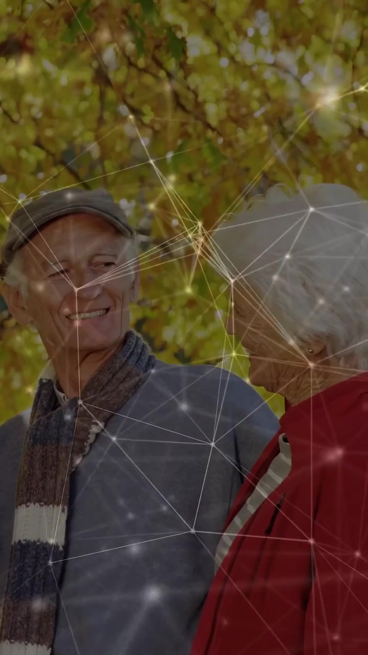 Vertical video: Senior man smiling starting eye contact with woman, camera panning net showing tech