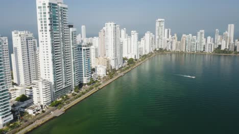 establishing drone shot of modern cartagena skyline on beautiful summer day