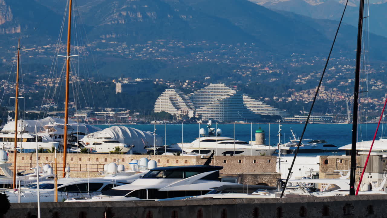 Distant view of the Marina Baie des Anges in Villeneuve-Loubet, France with the mountains on the background