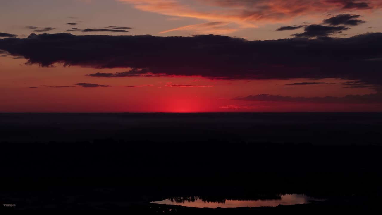 Aerial view of a beautiful orange-red colored sunset with vibrant, warm hues