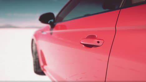 close-up of a red car door on a salt flat