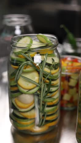 preserved zucchini and herbs in glass jars