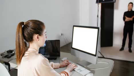 Female-photographer-reviewing-captured-photos-in-his-digital-camera