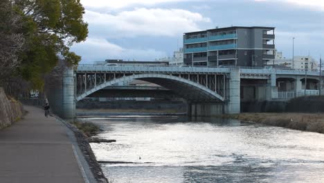 time-lapse of a river flowing under a bridge