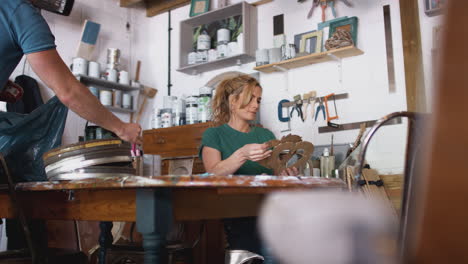 couple in workshop upcycling and working on craft projects