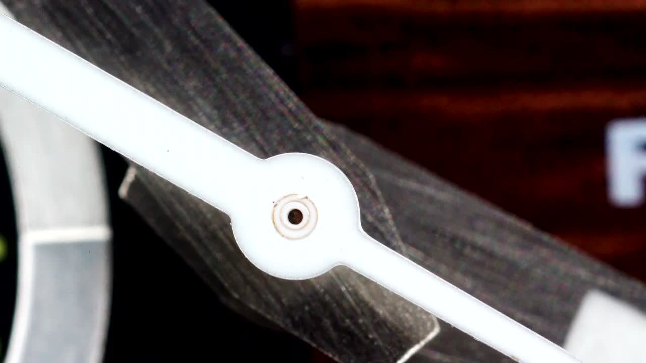 The round white metal on the center of the second hand on a macro shot