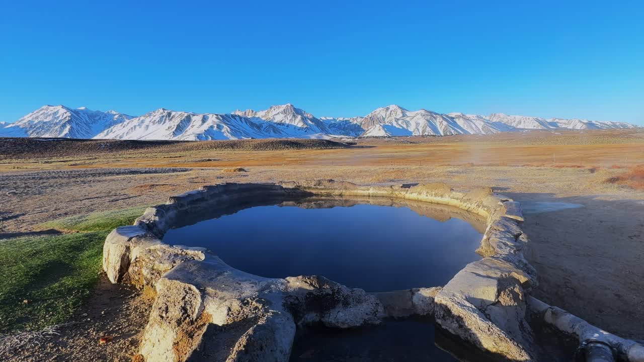 Winter early morning blue sky natural Hilltop Whitmore Wild Willys Hot Springs hot tub soak sunny sky snow covered Mammoth Mountain Minarets aerial drone Convict Canyon peaceful steam static