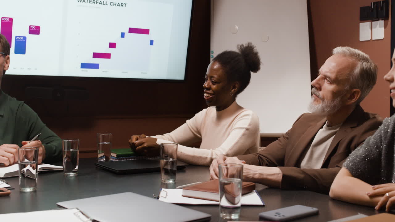 Business Meeting in Conference Room with Data Presentation