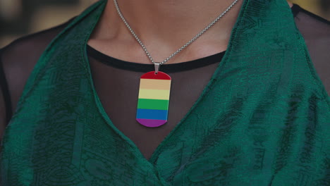 pride necklace on a woman wearing a green dress
