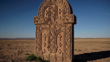 ornately carved stone tomb in a desert landscape