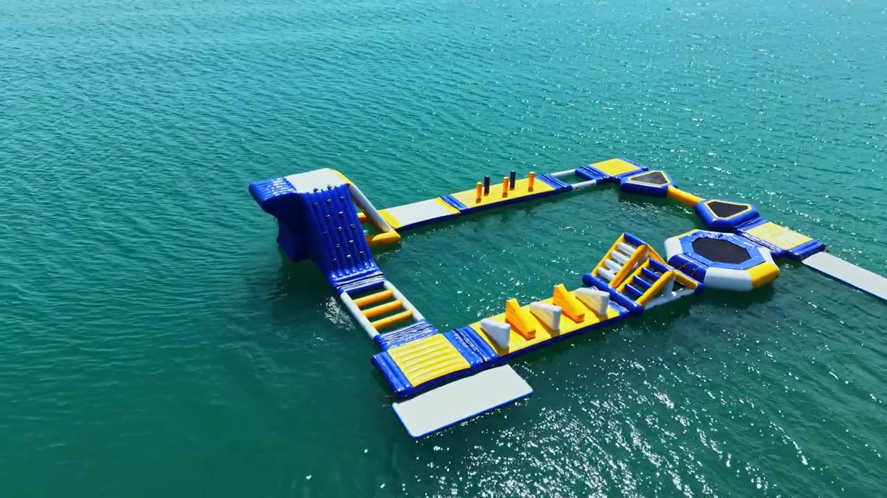 Water park features inflatable structures for fun activities in a sunny location during daytime