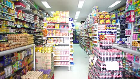 fixed clip of full grocery store shelves, filled with brightly coloured products