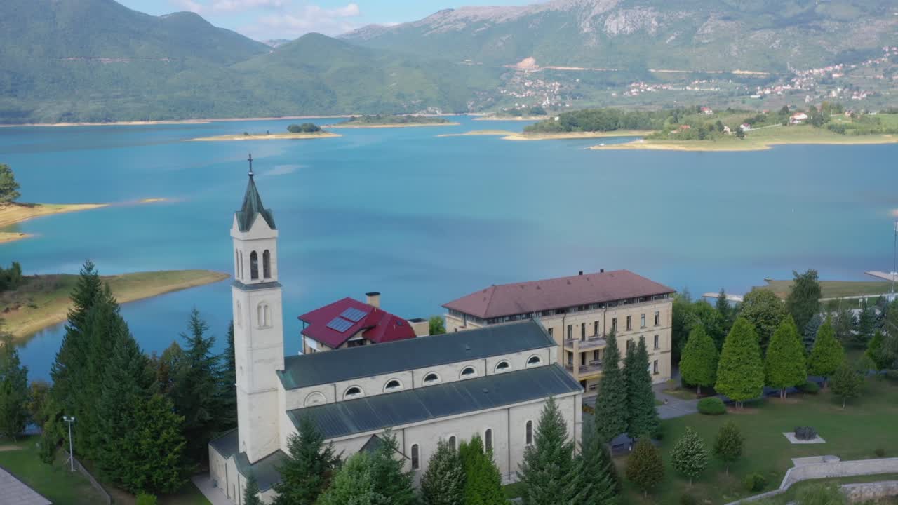 Franjevacki Samostan Monastery grounds in Bosnia and Herzegovina's Rama lake, Aerial dolly out shot