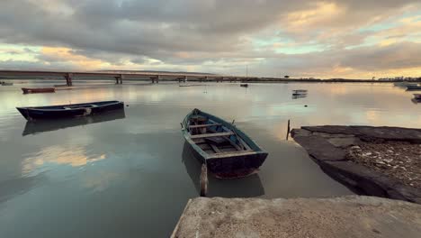 boats on a calm river at sunset