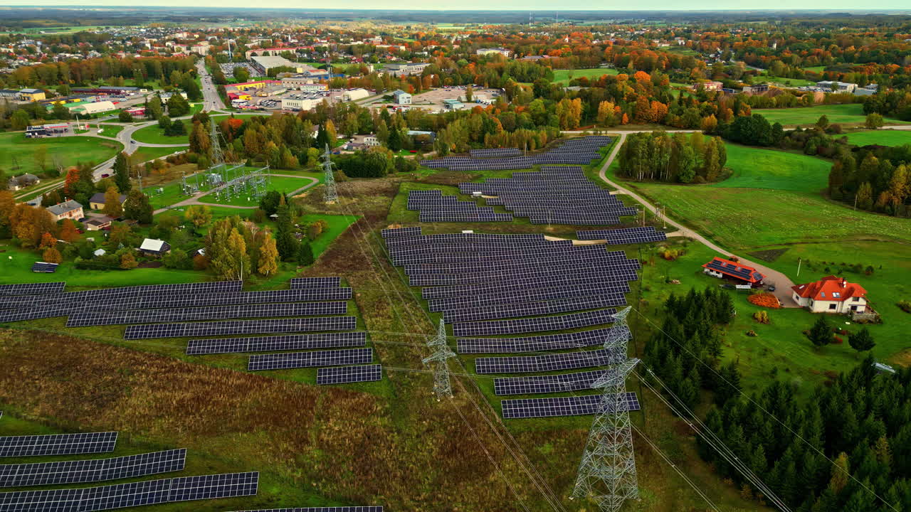 Solar panels in solar farm in green countryside, electricity generation.