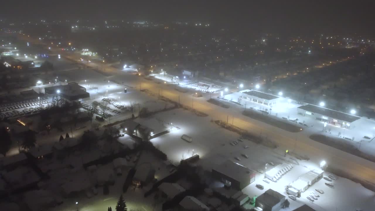 The city of Saint-Constant in Quebec with the streets illuminated at night and the streets covered in snow