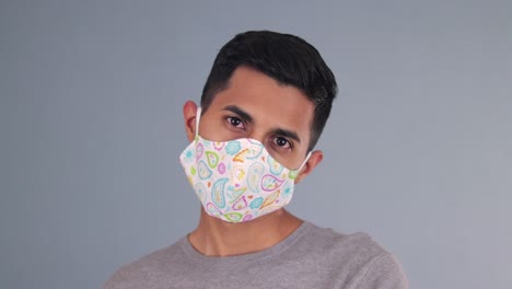 handsome hispanic model wearing a homemade face mask at the covid pandemic