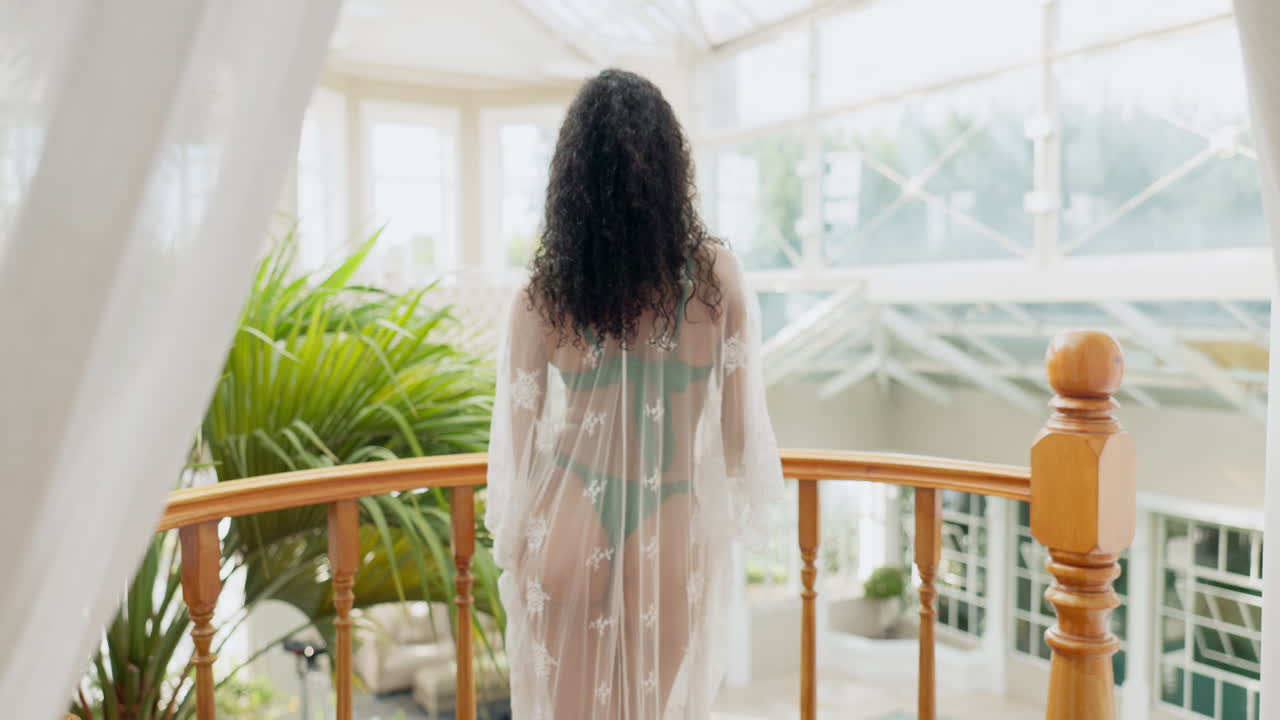 Woman with curly hair on balcony