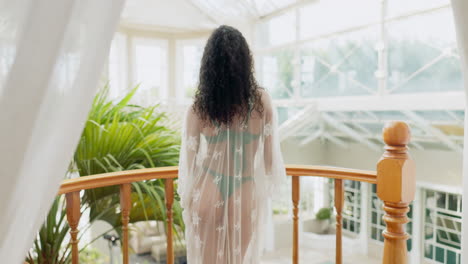 woman with curly hair on balcony