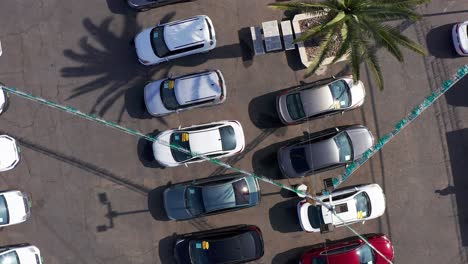 Rising-bird's-eye-spiral-aerial-shot-of-rows-of-cars-at-a-used-car-dealership