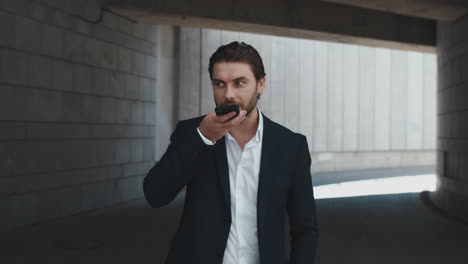 business man talking on phone loudspeaker at street. man standing at street