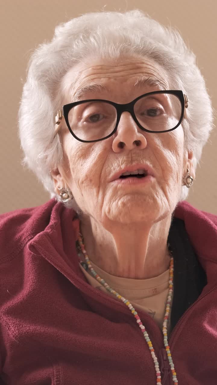 Elderly woman with short gray hair talking in nursing home