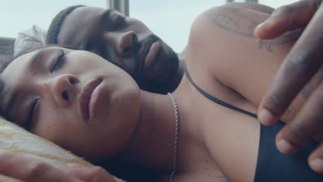 tender couple sleeping on bed at home