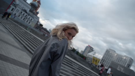 beautiful model posing city with blonde hair in urban buildings.