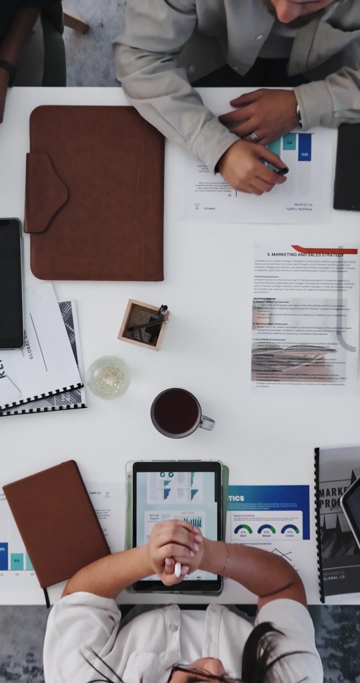 Business Colleagues Reviewing Marketing Strategy Documents in Office Meeting