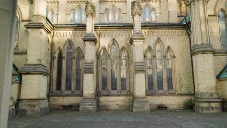 stained glass window bays and structural masonry buttress of gothic cathedral from the exterior