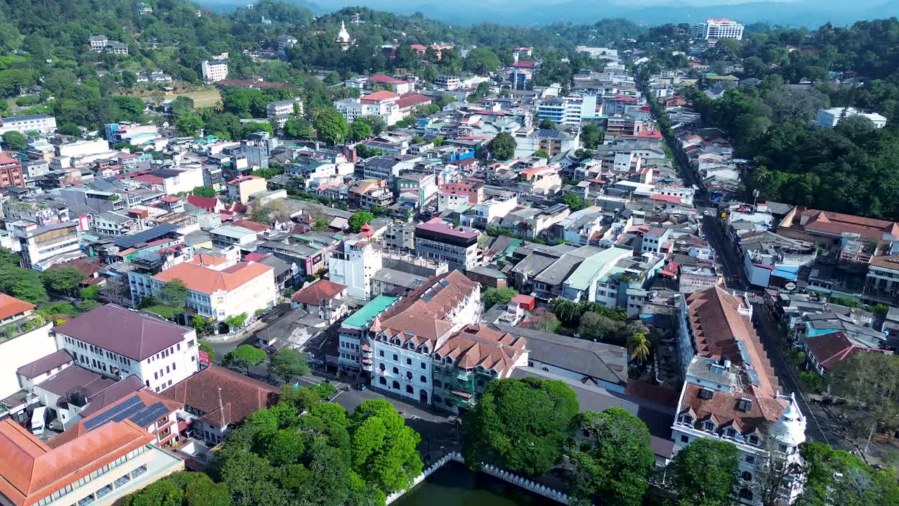 Aerial drone view of Kandy main town with city shops hotels apartment blocks on street landscape urban architecture Sri Lanka travel tourism Asia
