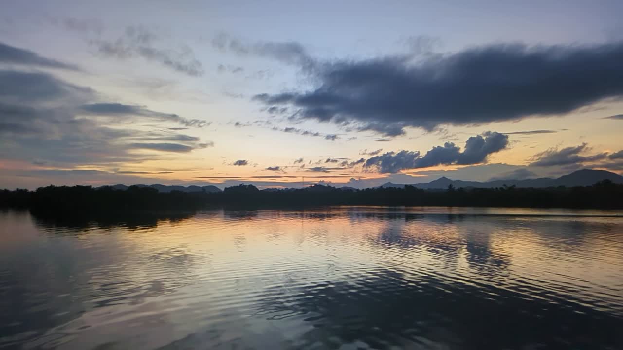 Scenic Sunset Over Tranquil Pajo River with Reflected Clouds in Catanduanes, Philippines