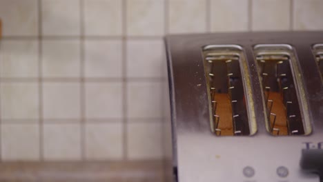 a close-up of a stainless steel, four slice toaster