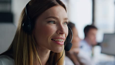 joyful agent speaking headset closeup. smiling woman professional talking client