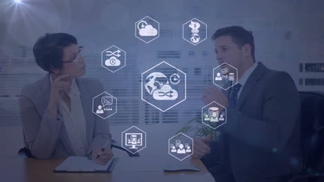 animation of business and cloud icons data processing over diverse business people in office