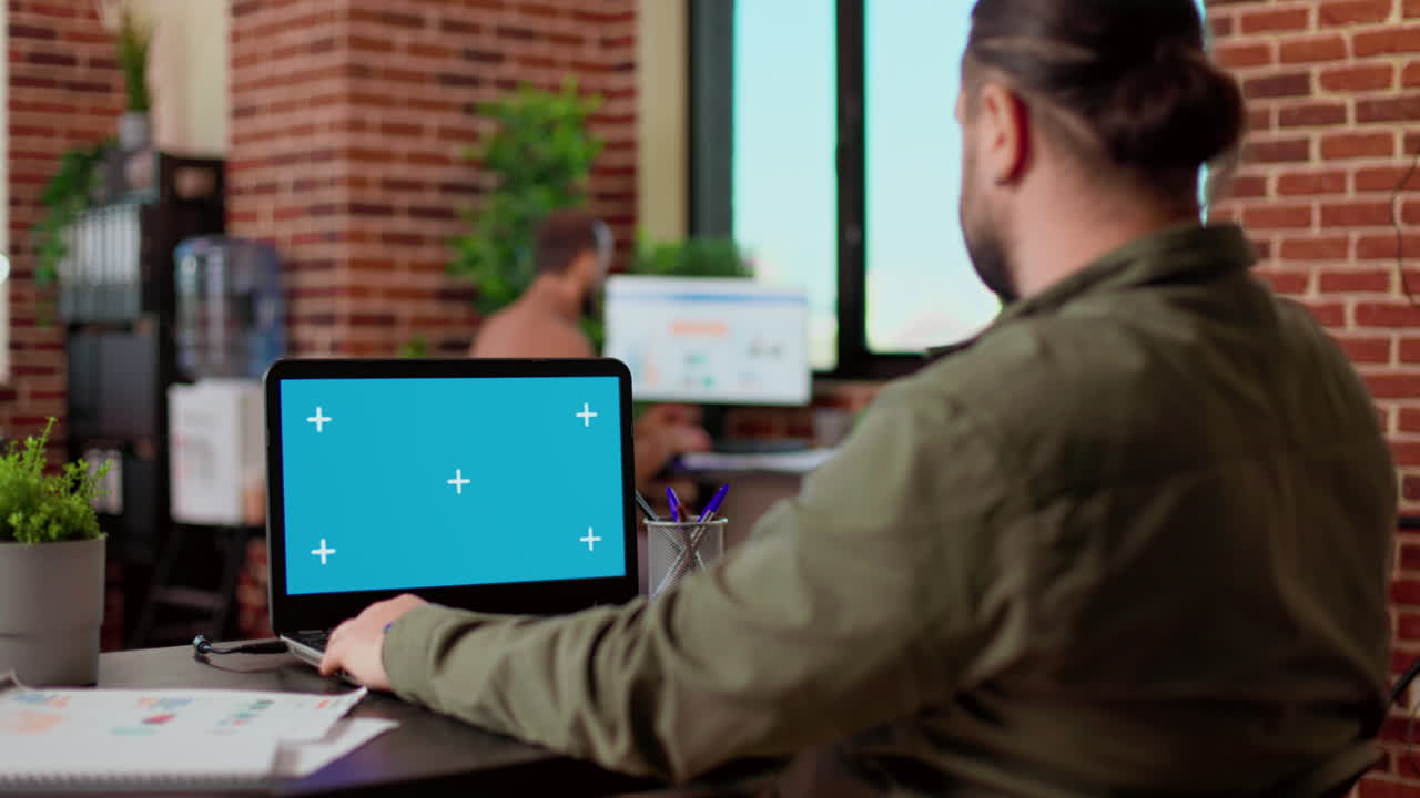 Startup employee analyzing business charts and greenscreen