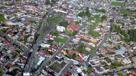 Top-drone-view-of-downtown-the-charming-town-of-chalco-Mexico,-and-view-of-the-downtown-and-roads-towards-Mexico-City