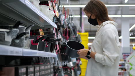 woman shopping for cookware in a supermarket