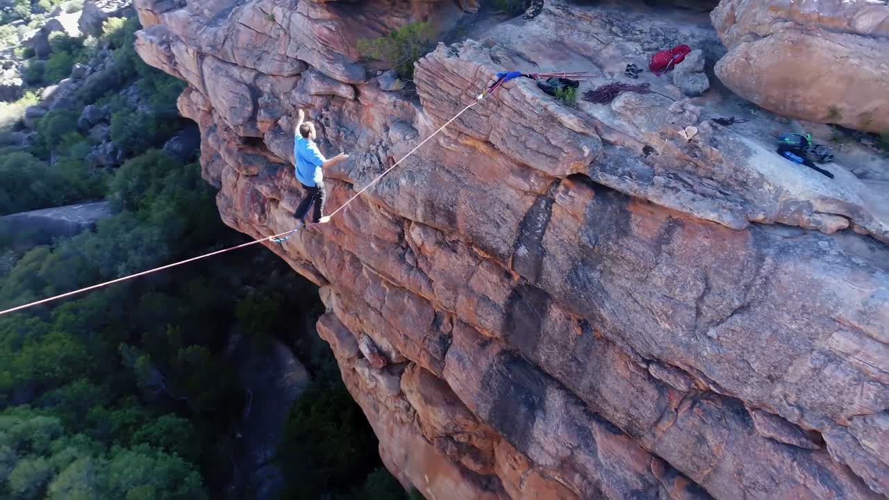 남자 하이라이너가 바위산 위를 로프로  ⁇ 고 4k를  ⁇ 습니다.