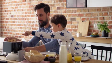 video of father and son having breakfast together