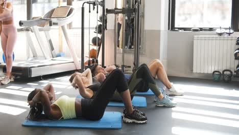 people doing crunches in a gym