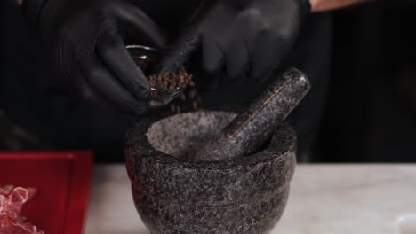 chef grinding pepper for meat