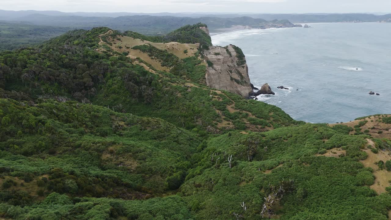 Aerial view of the cliffs and coastline near Muelle De Las Almas, a unique place in Chonchi, Chiloe Island, Chile. Dolly Forward