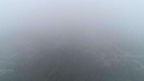 a drone slowly descends out of fog