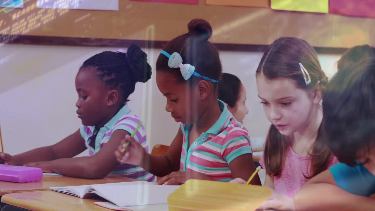 Focusing on student writing in notebook panning to students studying near yellow box in classroom