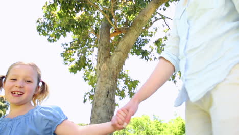 happy mother running with her little girl in the park