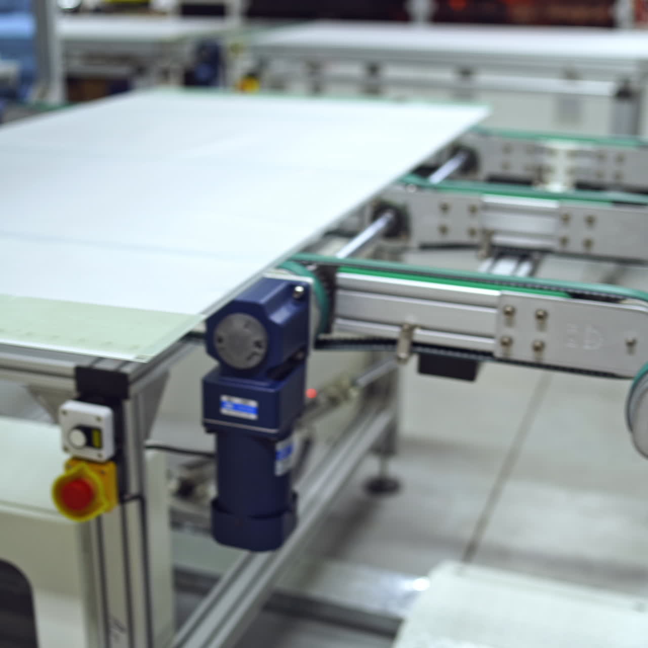 Close-up work of automated equipment for producing solar panels. Modernized factory with innovative technologies indoors.