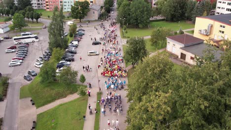 aerial view of a colorful parade in a city