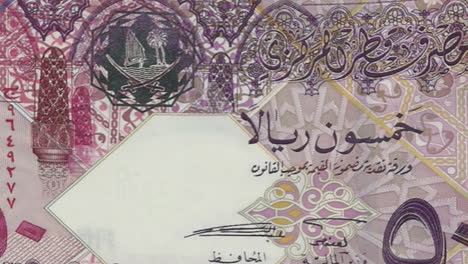 qatari 50 riyals banknote on green screen and detailed view